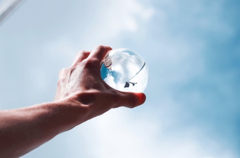 Hand holding glass ball